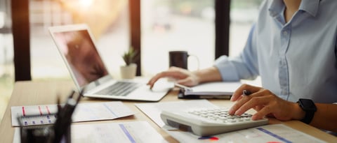 Businessman calculating finances at office desk. Concepts of finance management.
